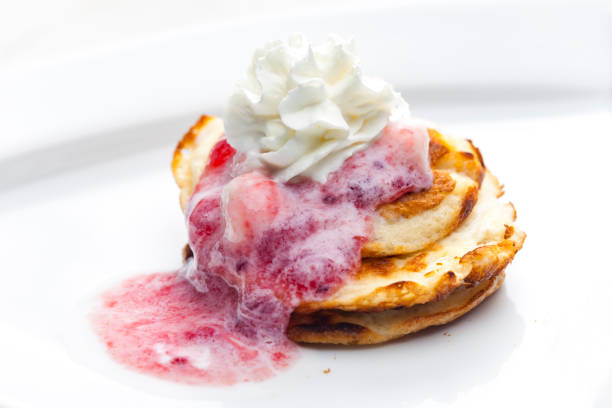 pancakes with fruit sauce and whipped cream