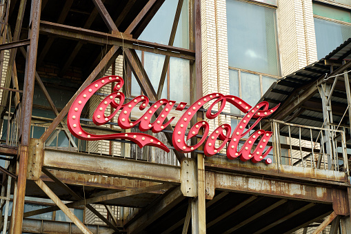 New York, USA - July 15, 2022: Old vintage sign of Coca-Cola drink on the facade of the building. Retro, design, style concept. High quality photo