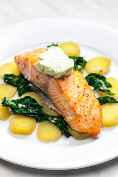 istock baked salmon with spinach leaves and potatoes 1408899508
