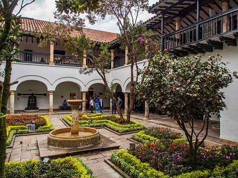 Bogota, Colombia - September 13, 2018: Exterior of the Fernando Botero Museum, Colombian master artist. At the top you could see  Monserrate Hill and church, Monserrate Monastery.
