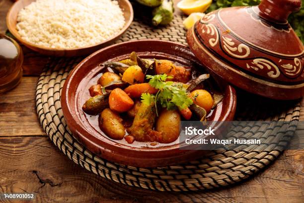 Moroccan Tagine With Rice Served In A Dish Isolated On Wooden Background Side View Stock Photo - Download Image Now