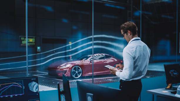 istock Engineering Research Agency Perform Aerodynamic Testing with a Modern Eco-Friendly Electric Sports Car in a Wind Tunnel. Professional Scientist Works on a Tablet Computer and Changes Testing Options. 1408904602
