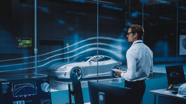 istock Engineering Research Agency Perform Aerodynamic Testing with a Modern Eco-Friendly Electric Sports Car in a Wind Tunnel. Professional Scientist Works on a Tablet Computer and Changes Testing Options. 1408904661