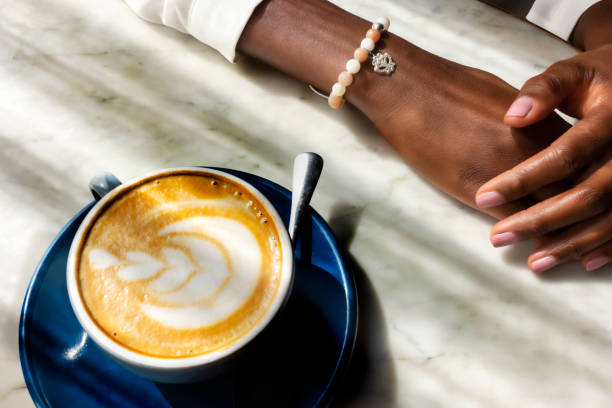 istock Hand near a cup of coffee 1408904728
