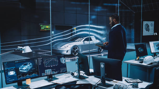 istock Engineering Research Agency Perform Aerodynamic Testing with a Modern Eco-Friendly Electric Sports Car in a Wind Tunnel. Professional Scientist Works on a Laptop Computer and Changes Testing Options. 1408905049