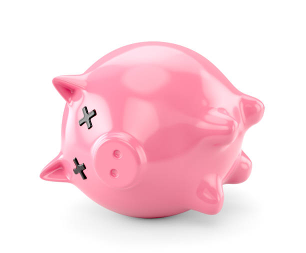Dead pink piggy bank upside down isolated on white background stock photo