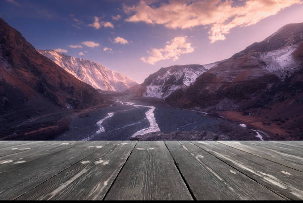Last light. View of the Caucasus mountain range with empty wooden table. Natural template landscape stock photo