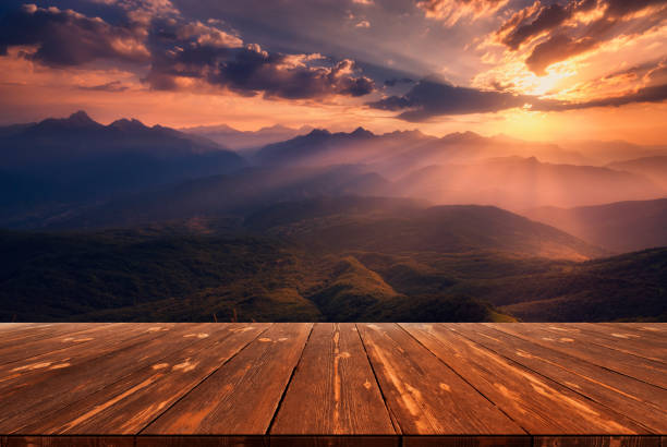 istock Sunrise over caucasus mountain range with empty wooden table. Natural template landscape 1408906319