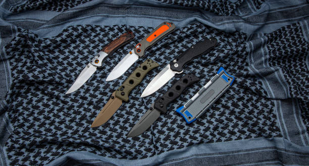 istock Various pocket knives with retractable blades. Light fabric background. 1408906945