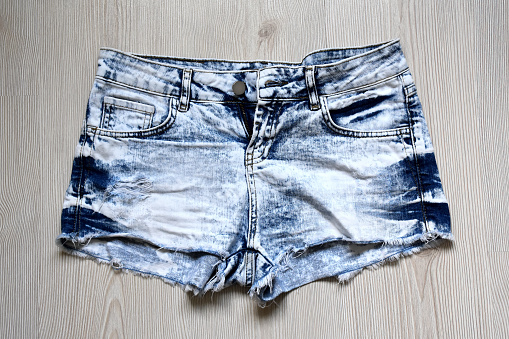 Mini denim jeans women shorts on the wood background