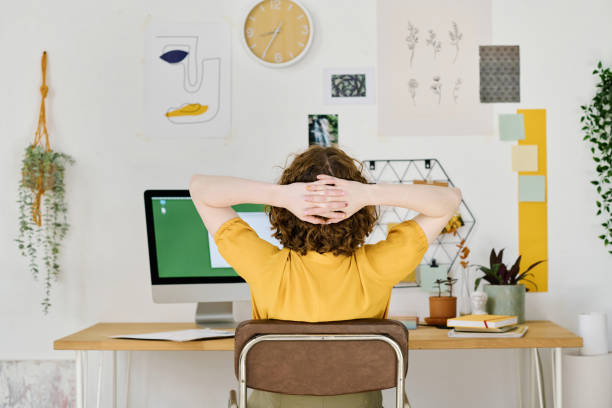 istock Rear view of designer having minute of rest while keeping hands behind head 1408908685