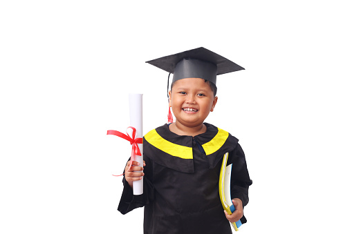 Portrait of a asian kindergarten boy feeling happy and excited by wearing simple and home-made school graduation clothes