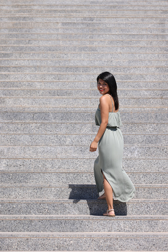 Pretty young lady walking up the steps