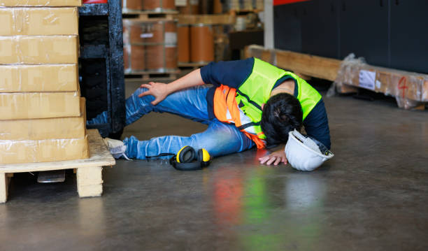 istock First Aid and safety first concept. Warehouse man worker lying down on floor after accident in warehouse factory. Professional engineering teamwork. Health insurance emergency accident in workplace. 1408913313