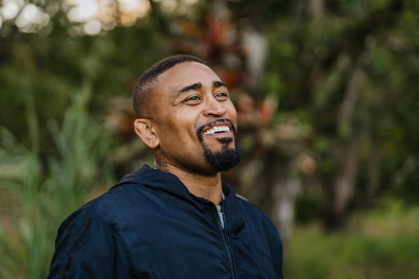 istock Smiling Latin American man in public park 1408913359