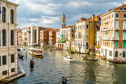 Venice - Italy July 5, 2022. View of Grand Canal in Venice, Italy with vaporetto and gondolas navigating on water.
