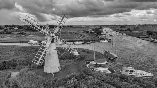 Heavy  low cloud, looking thunderous in this delightful black and white aerial view if the Thurne Windmill