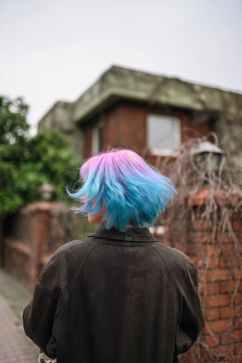 Portrait of stylish young girl with pink and blue ombre hair