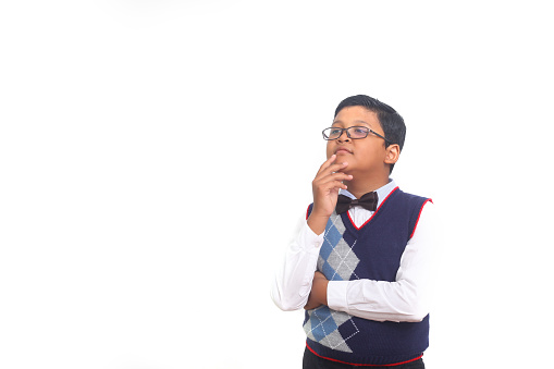 Little asian boy thinking an idea against white background