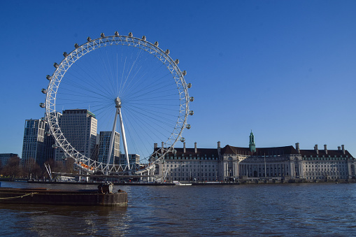London, UK - 17th January 2022. The London Eye and County Hall on a clear, sunny day.