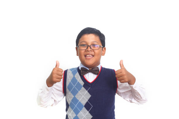 istock Asian school boy showing thumbs up. Isolated on white background 1408918350