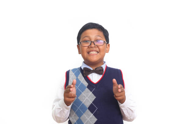 Asian school boy with hand gesture holds something