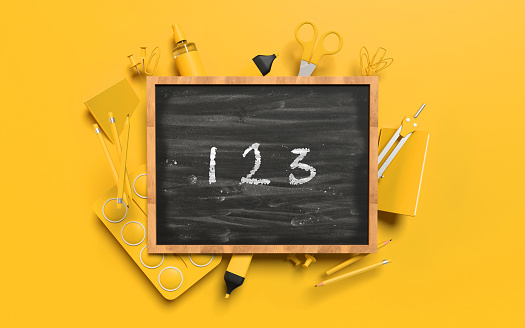 Back to School 123 counting math concept with school equipment behind a blackboard against yellow orange background. Educational concept. Easy to crop for all your design and print needs.