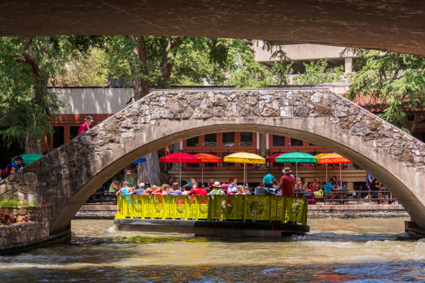 Tourists Keep Cool on a Boat Ride on the San Antonio River in San Antonio, Texas stock photo