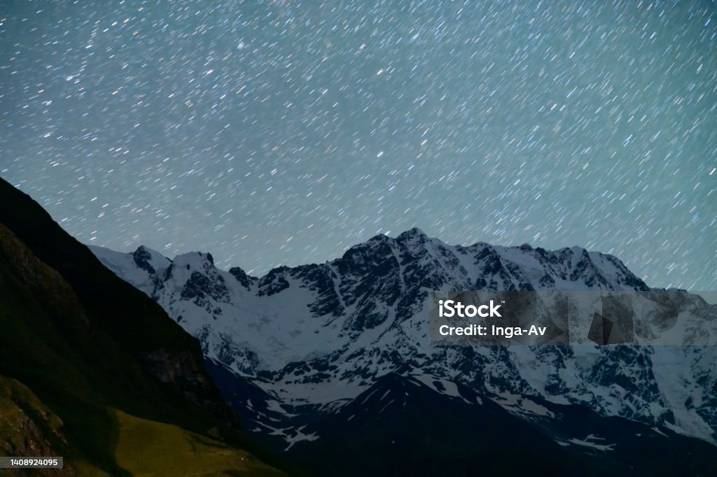 Beautiful night landscape. Beatuful Shkhara mountains under starry sky. Astronomy Stock Photo