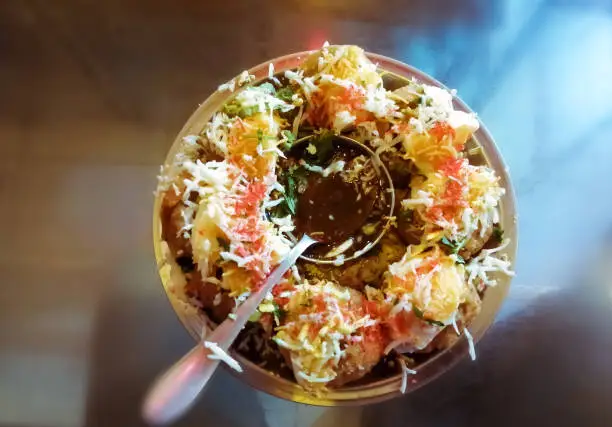 close up of Phuchka common street snack from Bangladesh. Panipuri or Golgappa. It's a round, hollow puri filled with a mixture of tamrind water and other chat items. Dahi or Doi phuchka.