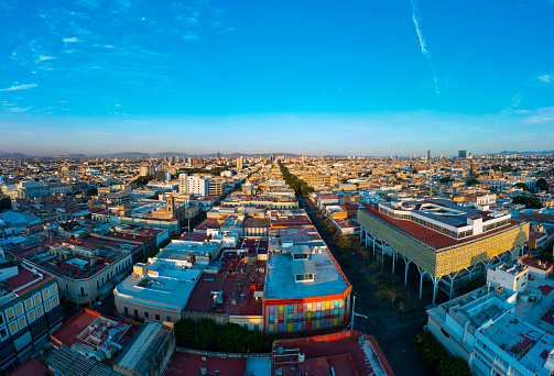 aerial images over the city of Jalisco full of colonial buildings on a quiet morning and sunrise in the background