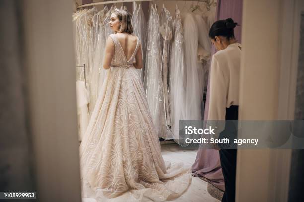 Woman Trying On A Wedding Dress Stock Photo - Download Image Now - Wedding Dress, 20-29 Years, Adult