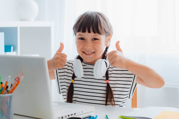 Little Winner. Excited Teen Girl Sitting In Living Room With Laptop Gesturing Yes Shaking Clenched Fists Getting A-Grade During Webinar At Home Celebrating Victory. Online School Tests Concept Little Winner. Excited Teen Girl Sitting In Living Room With Laptop Gesturing Yes Shaking Clenched Fists Getting A-Grade During Webinar At Home Celebrating Victory. Online School Tests Concept report card stock pictures, royalty-free photos & images