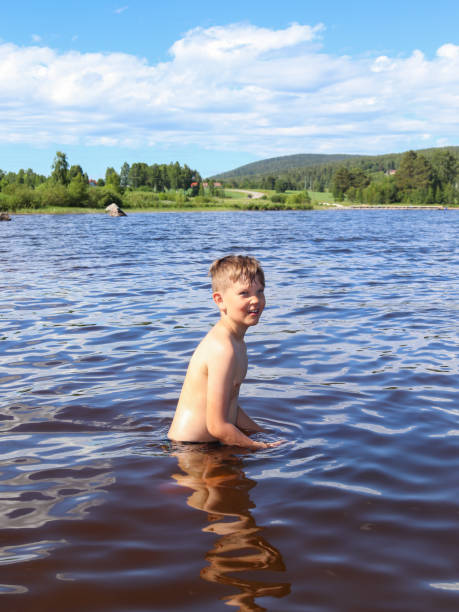 istock Little happy boy swimming in lake 1408931507