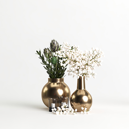 Elegant black glass bottles as home decor on soft light white wood table with silver decorative leaves, copy space.