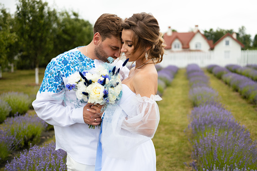 Young couple in love bride and groom, wedding day in summer. Enjoy a moment of happiness and love in a lavender field