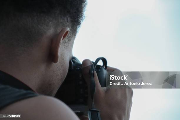 Boy Taking A Picture With A Camera Stock Photo - Download Image Now - 20-24 Years, Adults Only, Camera - Photographic Equipment