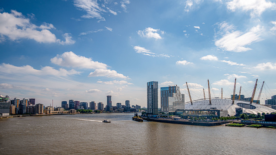 London, United Kingdom - June 24, 2022:  View of the Millennium  Dome from the Thames River. It houses the O2, a large entertainment district including restaurants, night clubs, an indoor arena, and exhibition space.