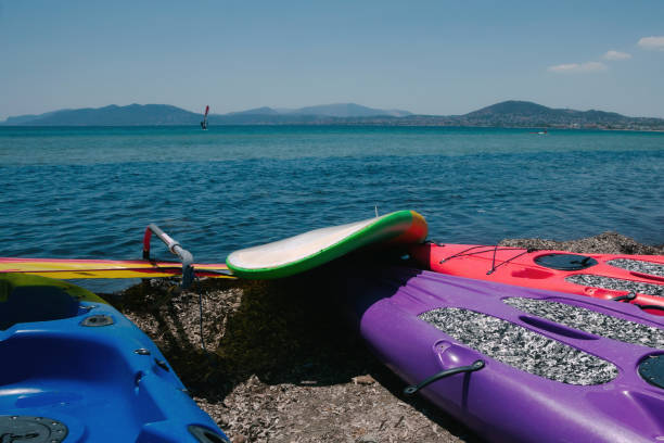 istock Kayaks and windsurf on beach. 1408949354