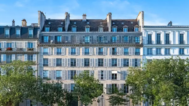 Paris, ile saint-louis and quai de Bethune, beautiful ancient buildings, blue hour on the Sully bridge