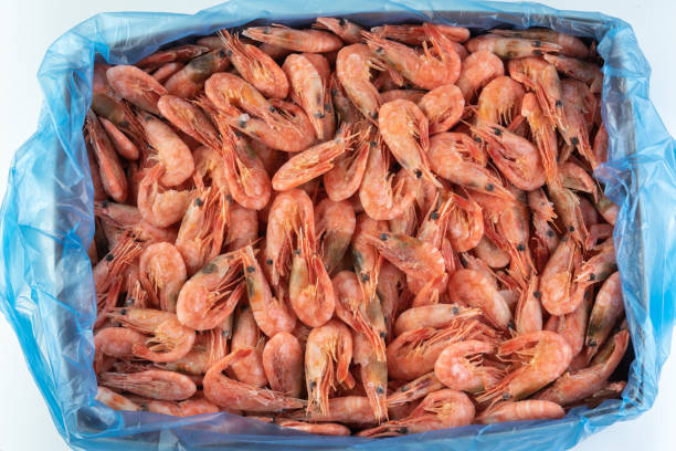 istock Frozen shrimp in a cardboard box. For wholesale. 1408953815