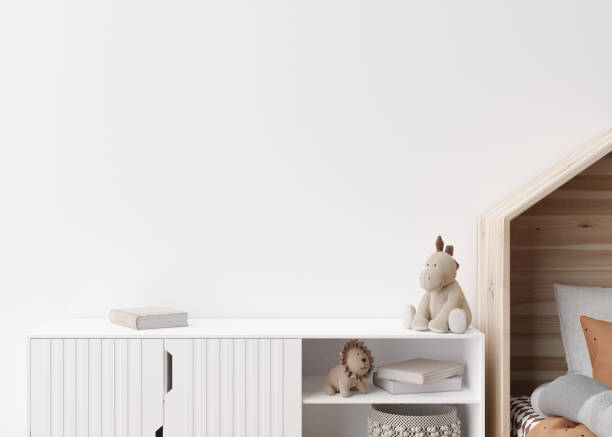 istock Empty white wall in modern child room. Mock up interior in scandinavian style. Copy space for your picture or poster. Bed, sideboard, toys. Cozy room for kids. 3D rendering. 1408953848