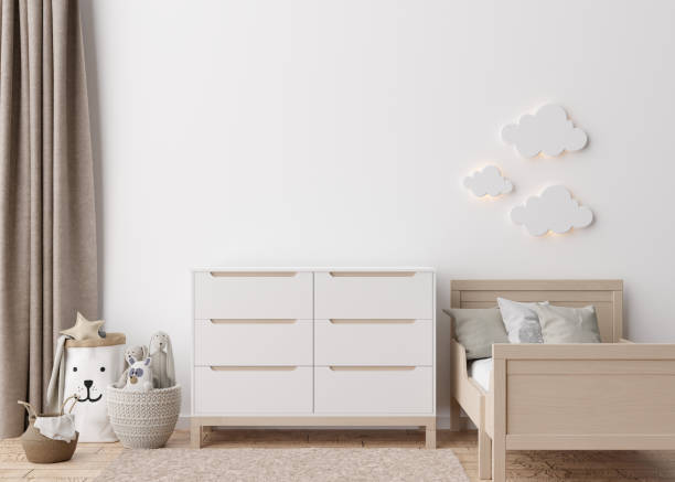 istock Empty white wall in modern child room. Mock up interior in scandinavian style. Copy space for your picture or poster. Bed, sideboard, toys. Cozy room for kids. 3D rendering. 1408953849