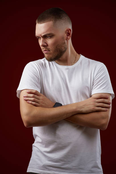 istock handsome man in a white t-shirt thinks about something 1408954183
