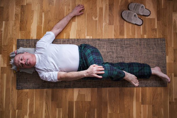 istock Senior caucasian man doing yoga Spine twisting pose 1408954377