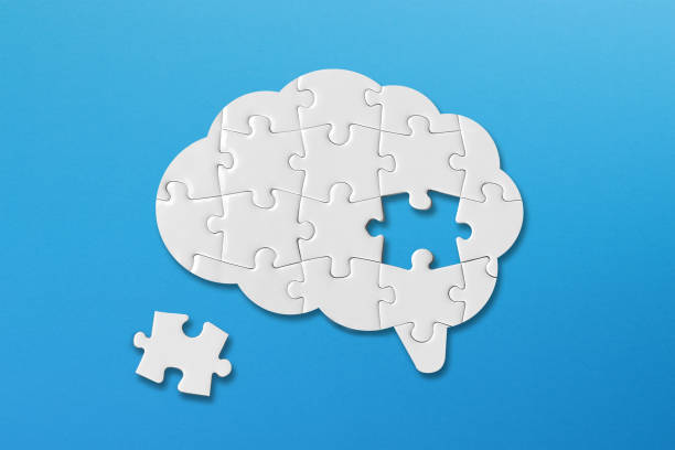 istock Brain shaped white jigsaw puzzle on blue background, a missing piece of the brain puzzle, mental health and problems with memory 1408957630