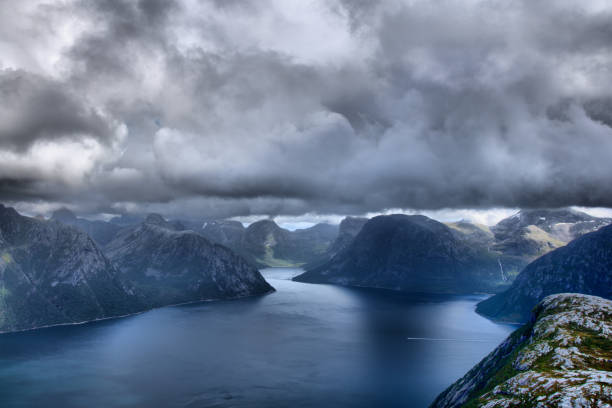 on the top of norwegian mountain right under the clouds stock photo