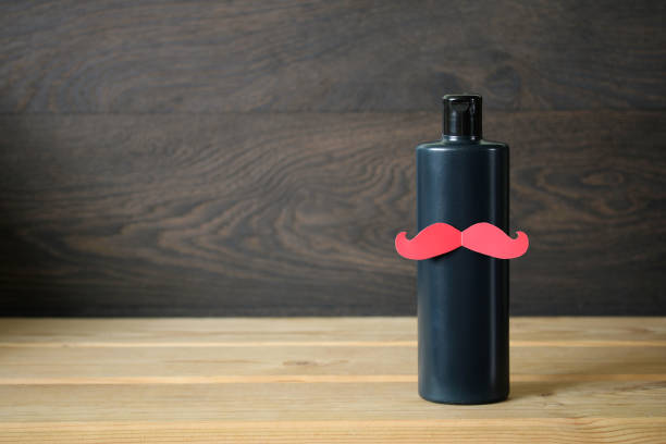 istock Men's shampoo with a paper mustache. 1408959285