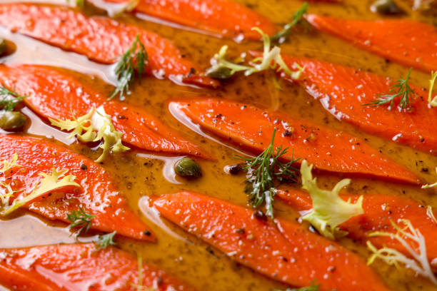 sockeye carpaccio with sauce on a white plate macro close up
