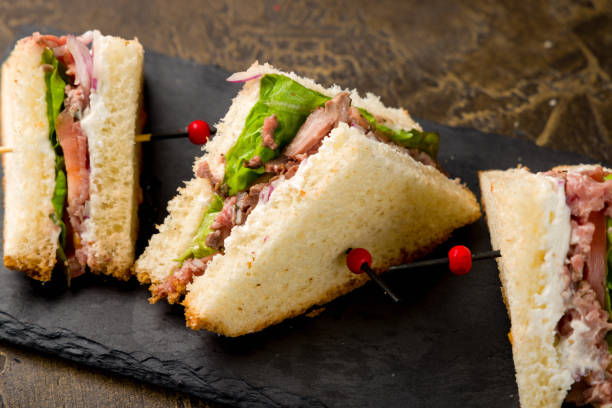 istock sandwich with beef and vegetables on black stone plate 1408964091